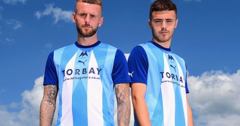 players wearing torquay united 2023-24 away shirt in white and sky blue